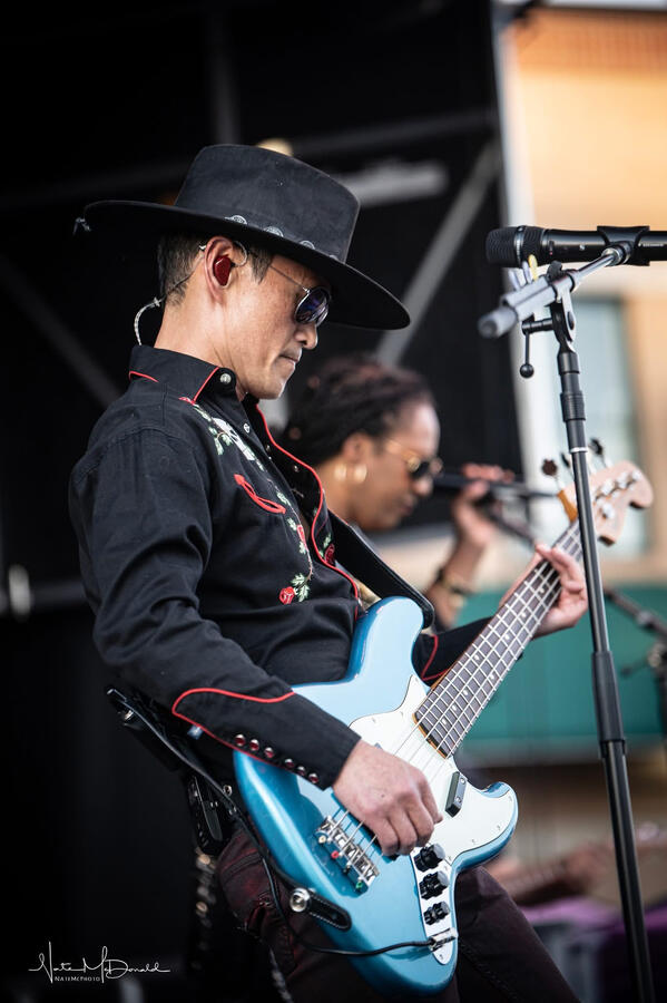 High-energy stage moment: OrrickBass with cowboy hat and Western shirt at Fridays on The Plaza in Cheyenne, WY. High-energy stage moment: OrrickBass with cowboy hat and Western shirt at Fridays on The Plaza in Cheyenne, WY.